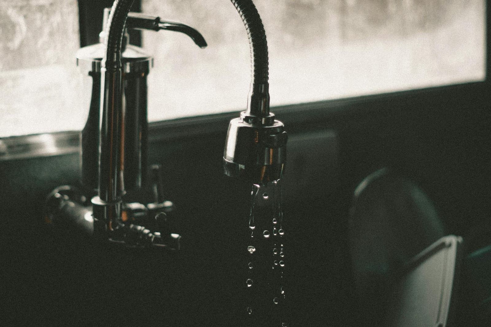 Close-up of a modern chrome kitchen faucet — the fixture installed and tested on every faucet job